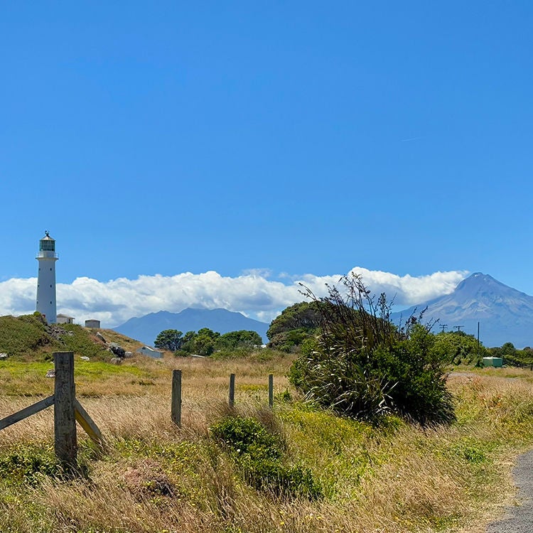 Cape Egmont Lighthouse at Pungarehu and Mount Taranaki.