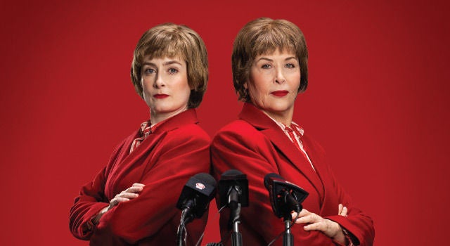 Two woman in red, back to back and looking powerful.