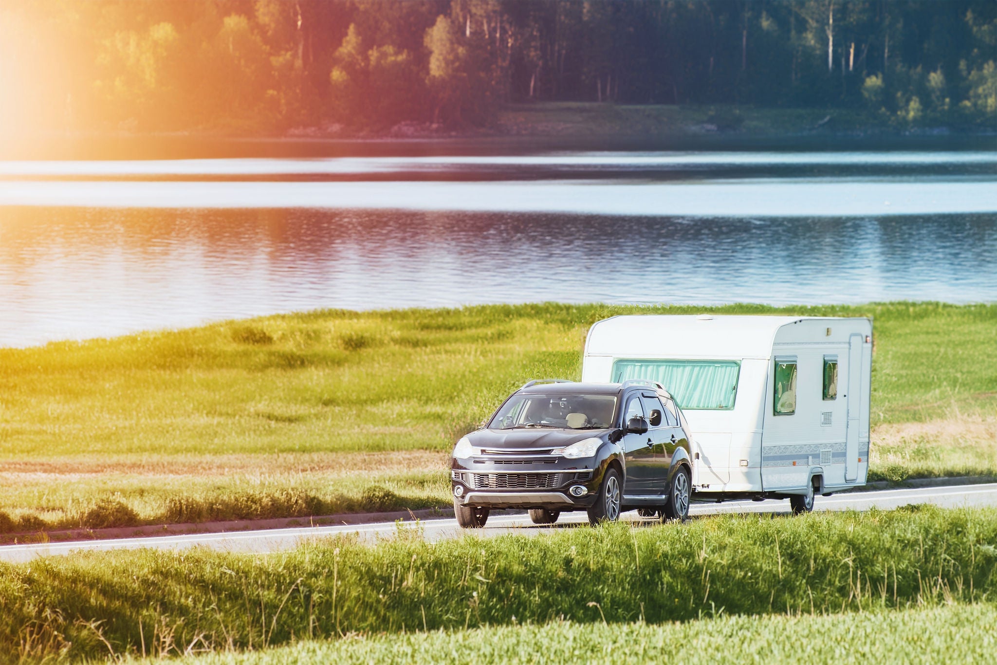 SUV pulling a caravan in nature