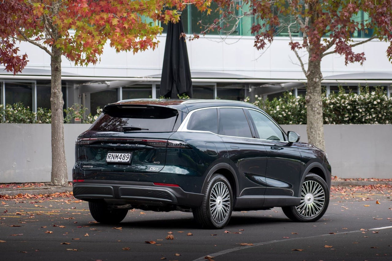 rear quarter view of dark green SUV