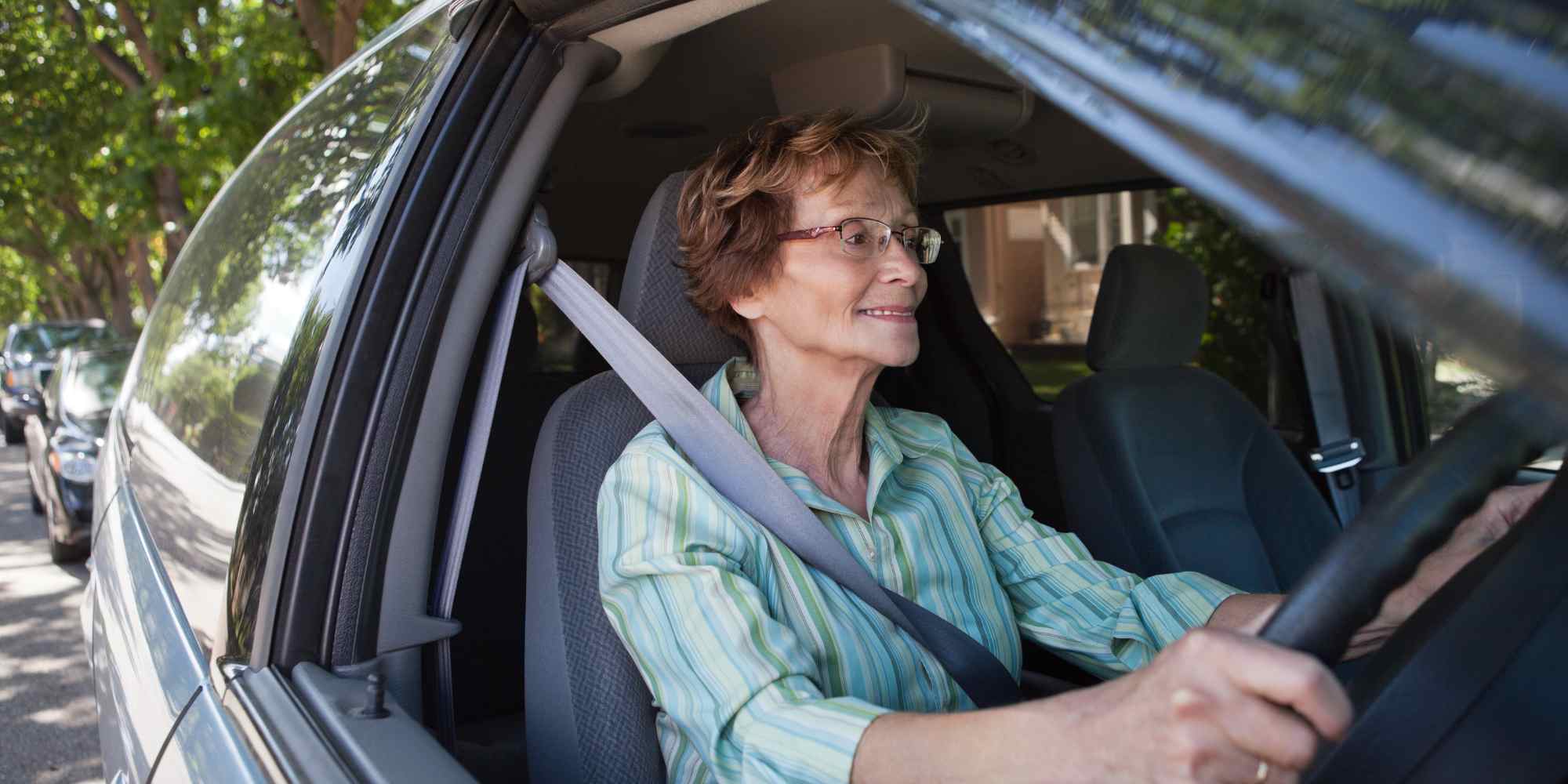 Elderly woman driving car