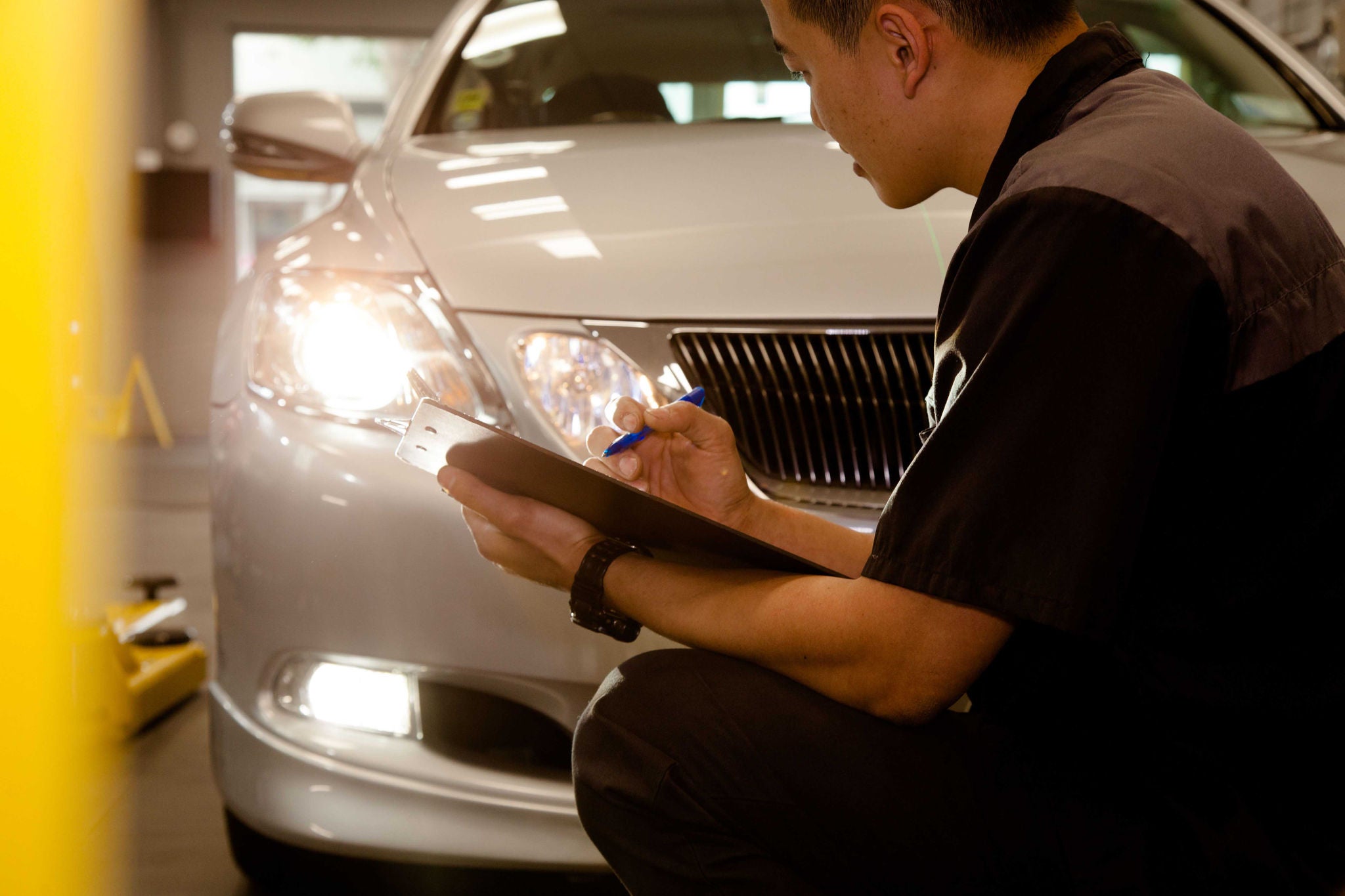 Vehicle inspector in workshop