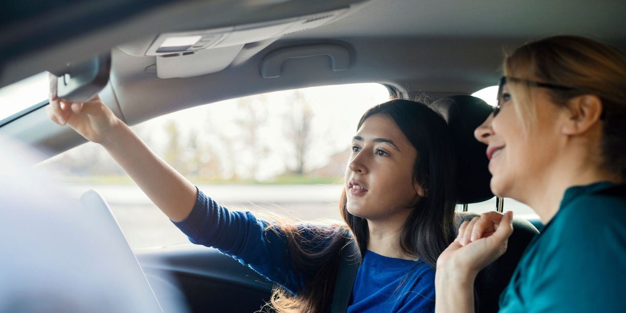 A woman driving instructor with a woman student driver 