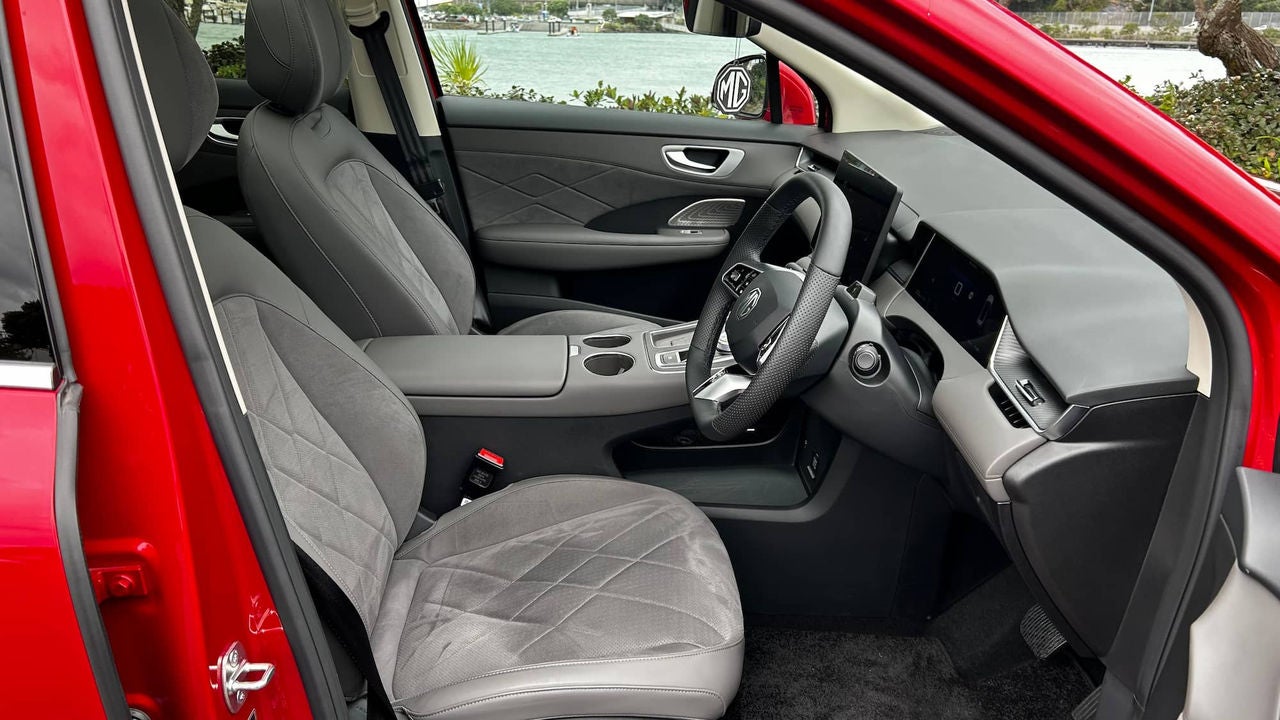 Front interior of an MG electric SUV showing the seats, dashboard, and centre console.