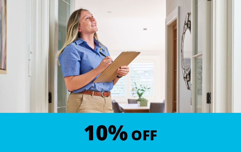 property inspector in home hallway holding a clipboard with 10% Off caption