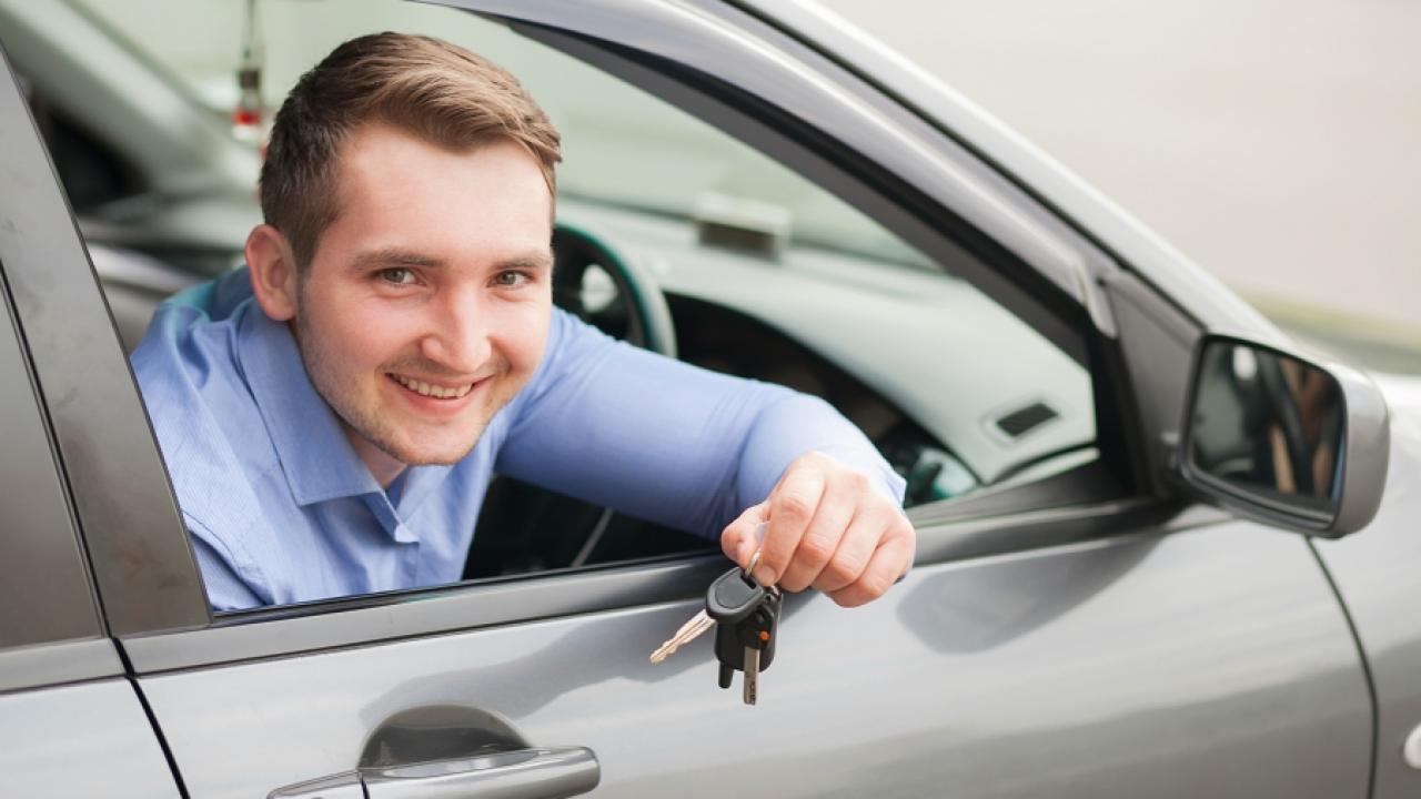 New car owner smiling at the camera