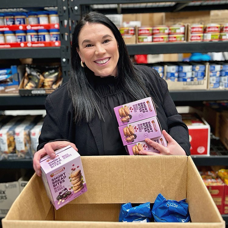 Sarah Page helps pack a food parcel at the Kindness Collective.
