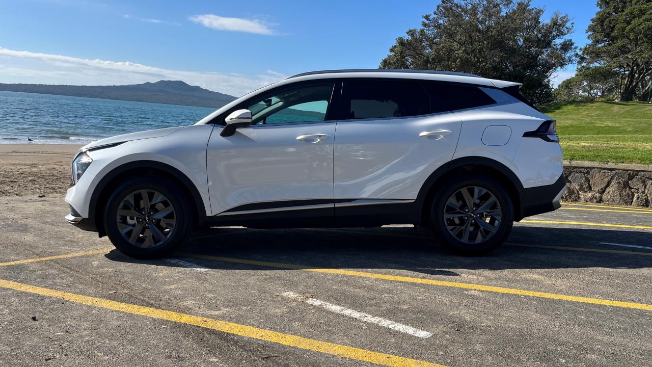 2024 Kia Sportage Hybrid Earth parked on the beach side