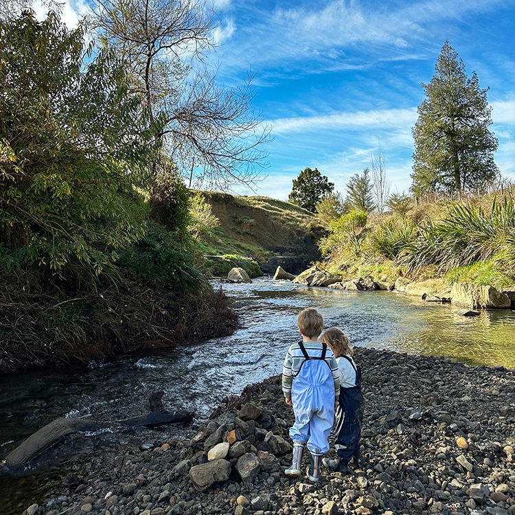 The children play in the river at Ripples Retreat. Photo by Monica Tischler.