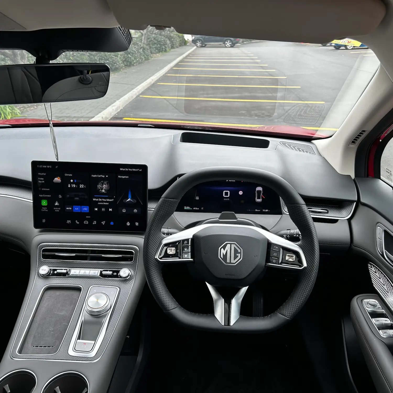Interior dashboard and driver controls of an MG electric SUV.