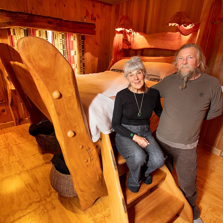 Brian and Karen with their enormous, handmade bed. Photo by Tim Cuff.