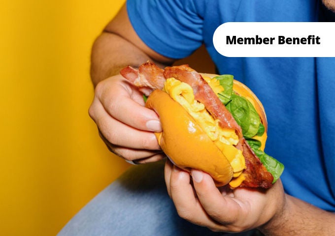 Hands holding an Egg'd breakfast sandwich
