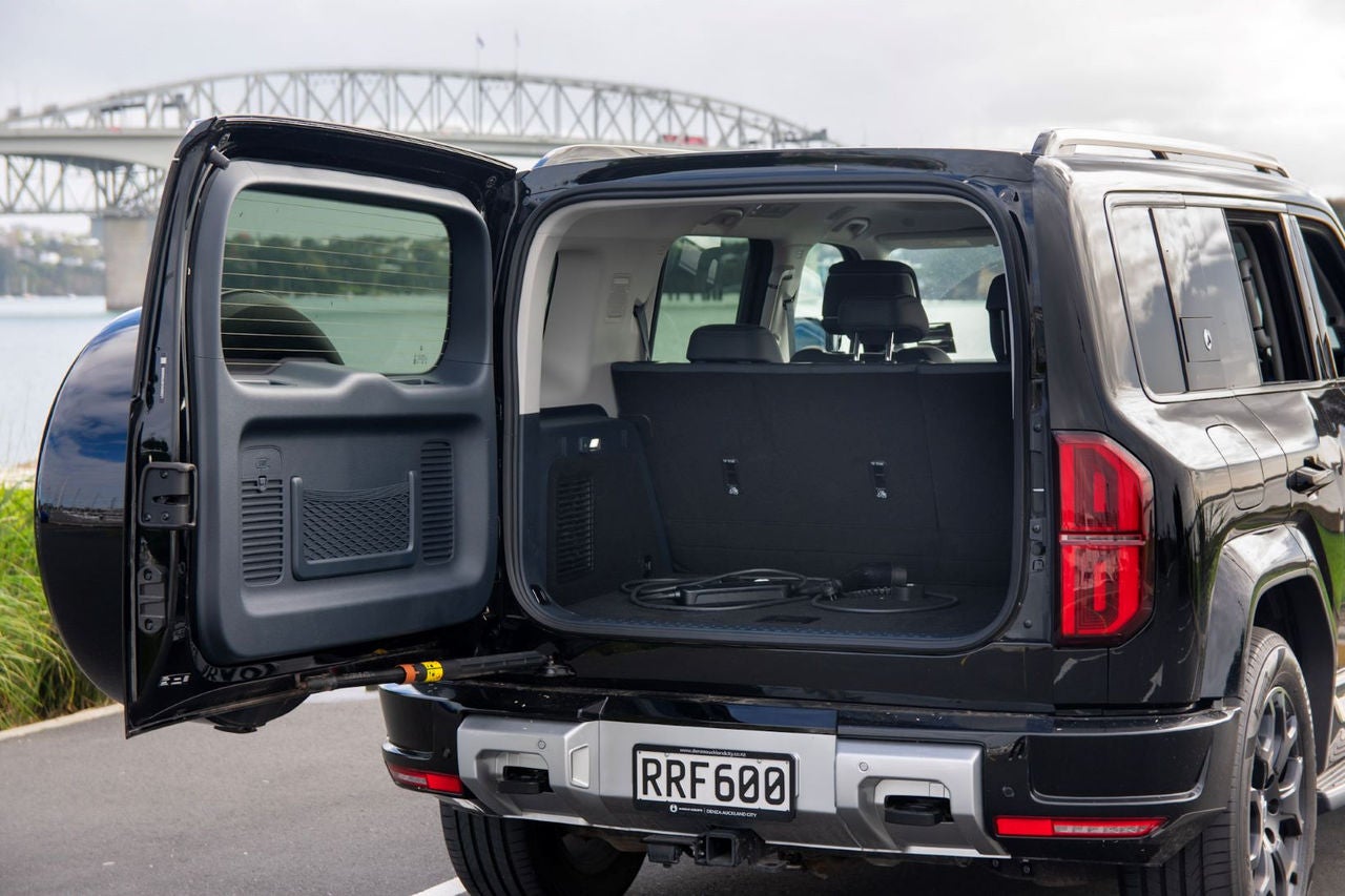 view of boot with door open showing charging cable