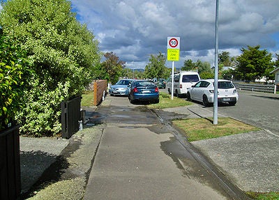 Photo of two cars parked illegally on the footpath
