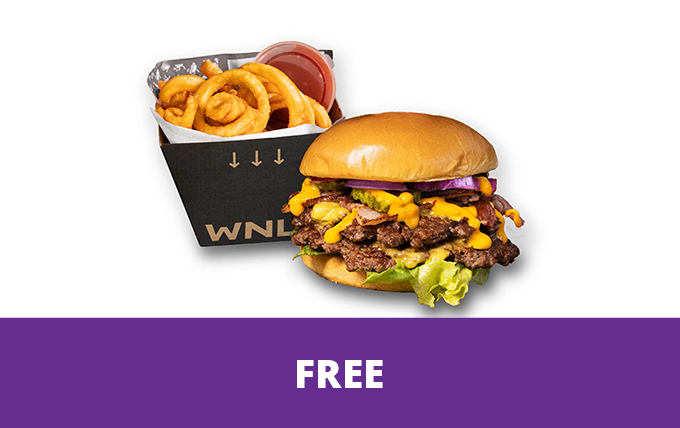 Promotional image showing a cheeseburger topped with melted cheese, pickles, red onion, lettuce, and sliced beef, served alongside a carton of curly fries with dipping sauce on a light grey background. A purple banner along the bottom contains the word “FREE” in large white text.