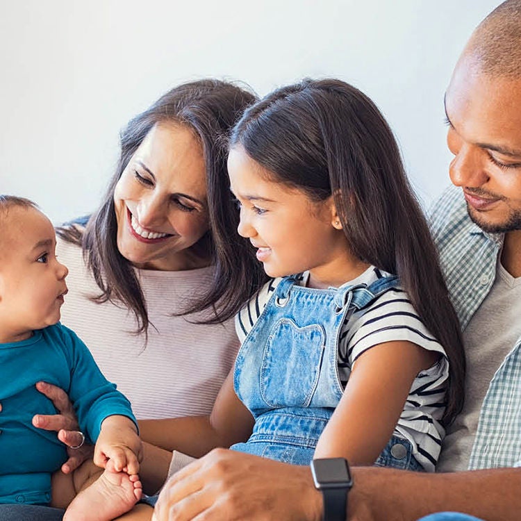 Young family of a mum, dad, child daughter, and a baby