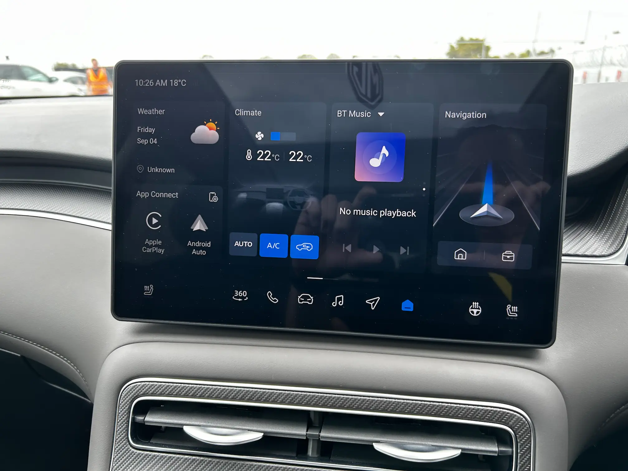 MG electric SUV touchscreen displaying navigation, climate, and connectivity controls.