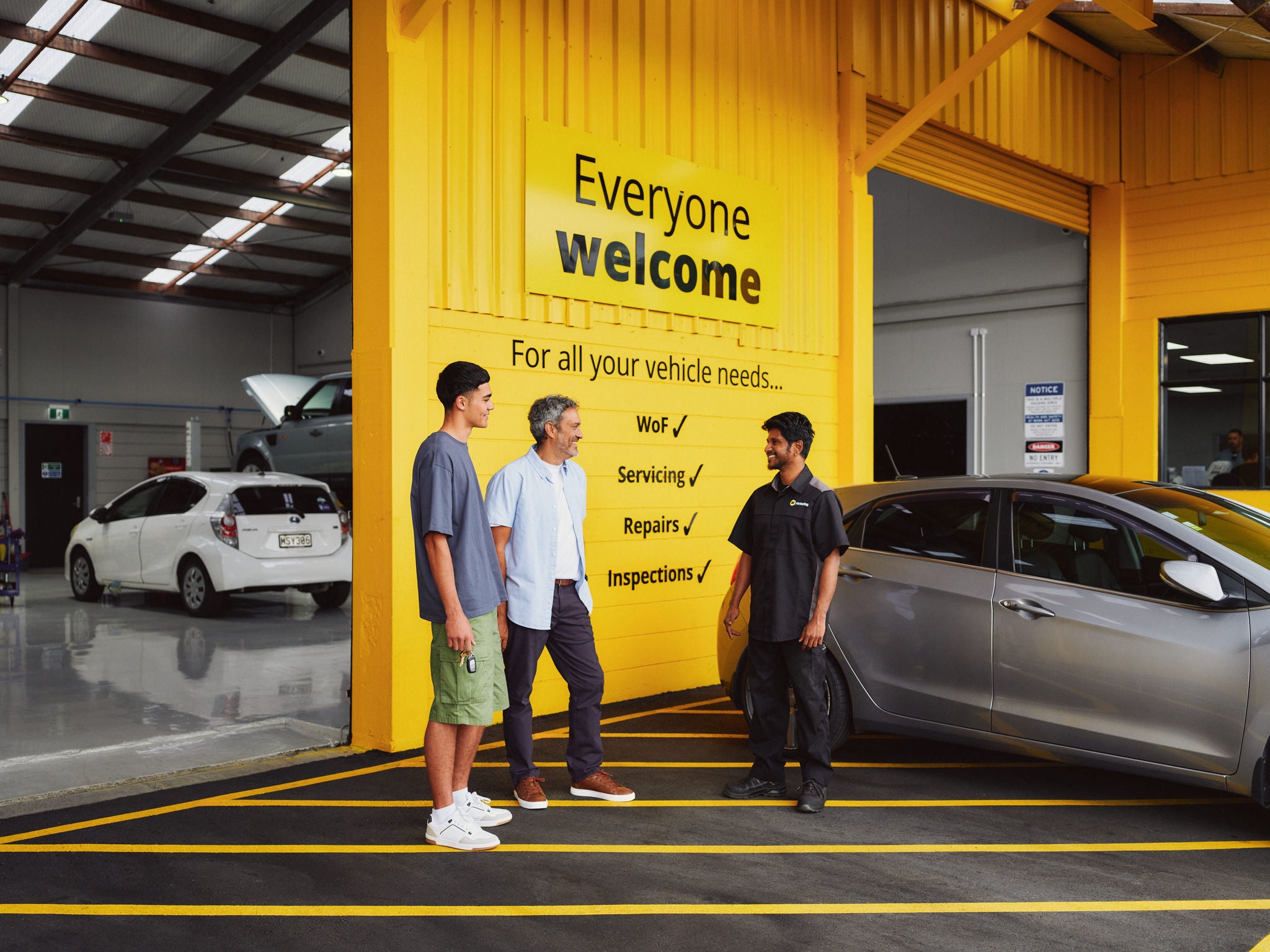 Man and son handing over car at an AA Auto Centre