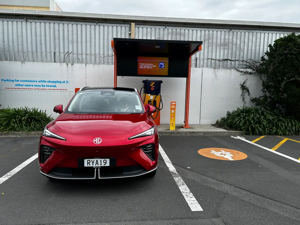 Red MG electric SUV parked at an EV charging station.