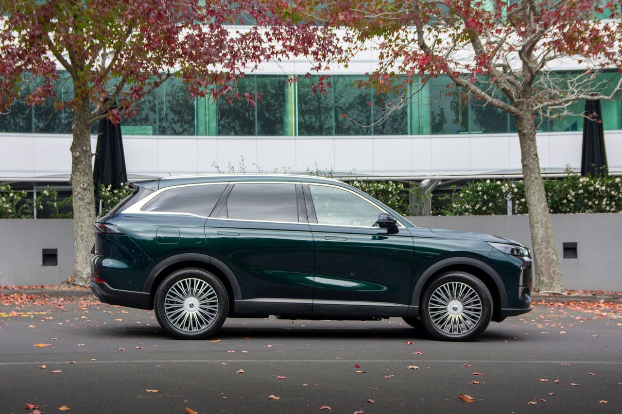 side view of dark green SUV