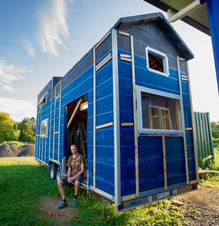Matthew Lillis with his partially completed tiny house.