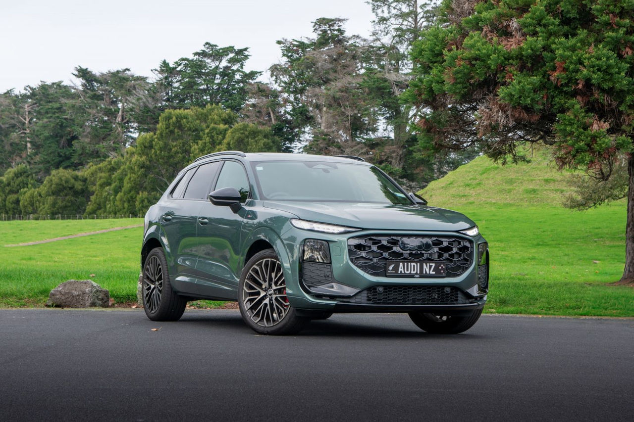 Crossover SUV in front of grass background