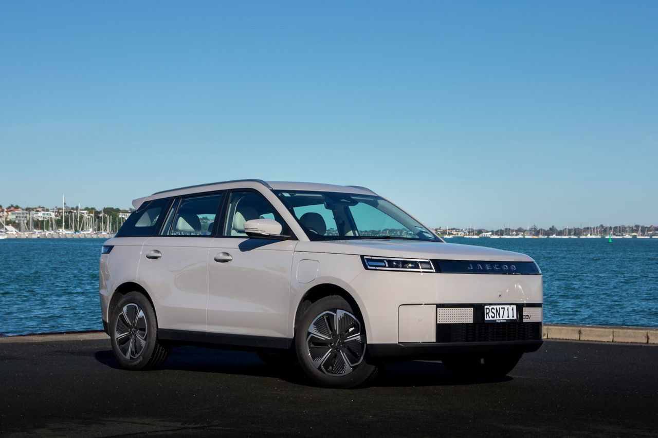 front quarter view of grey SUV in front of water