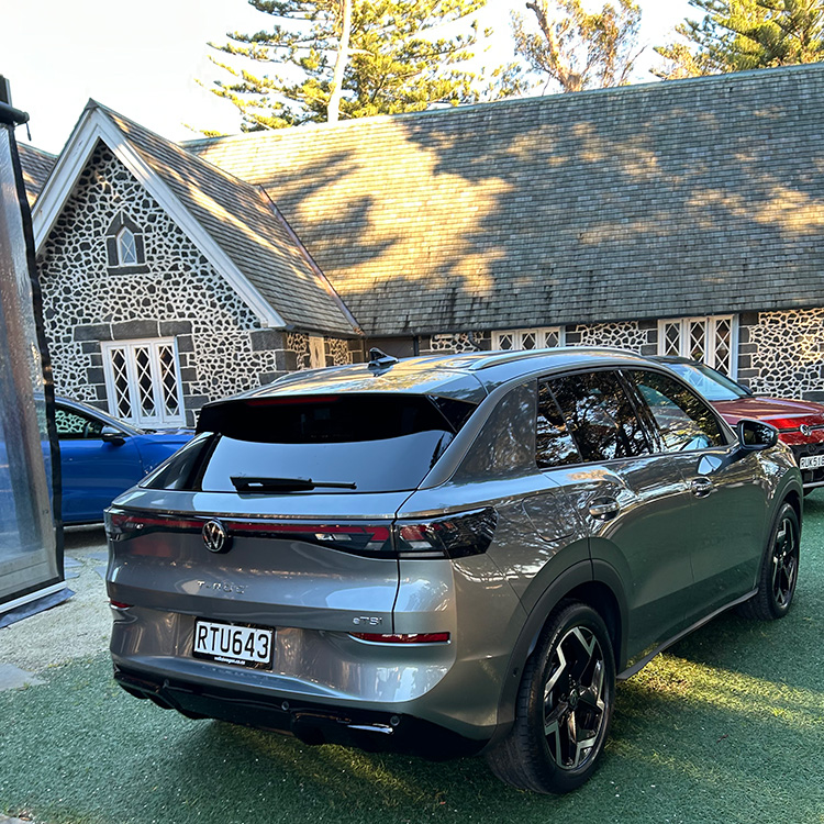 Crossover SUV in front of wooded background