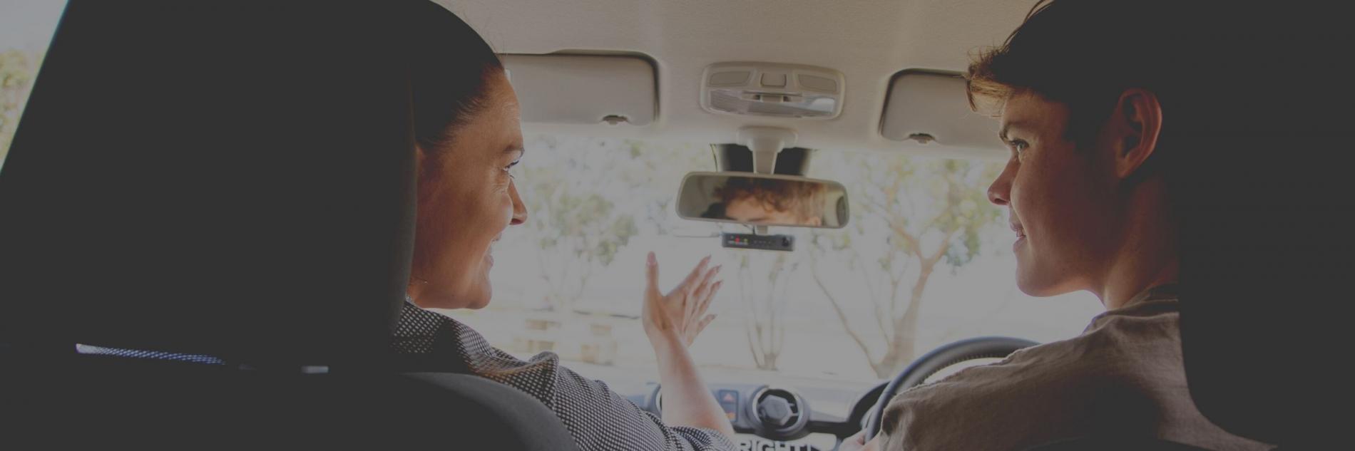 AA driving instructor teaching a student driver inside a car