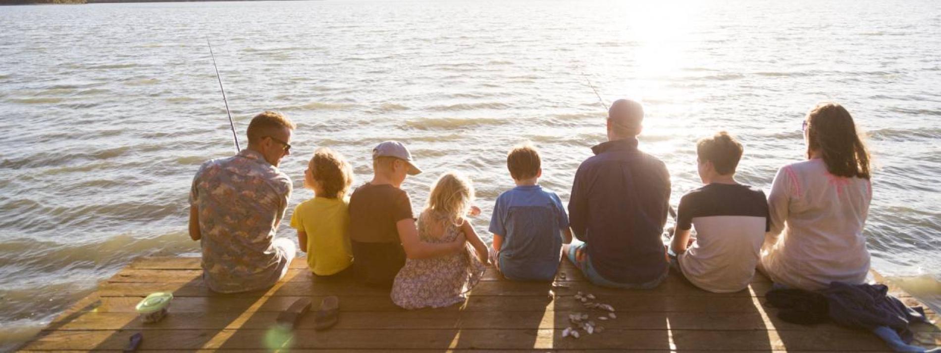 Family fishing together off a wharf