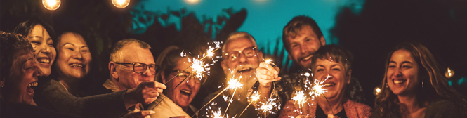 People smiling and celebrating with sparklers