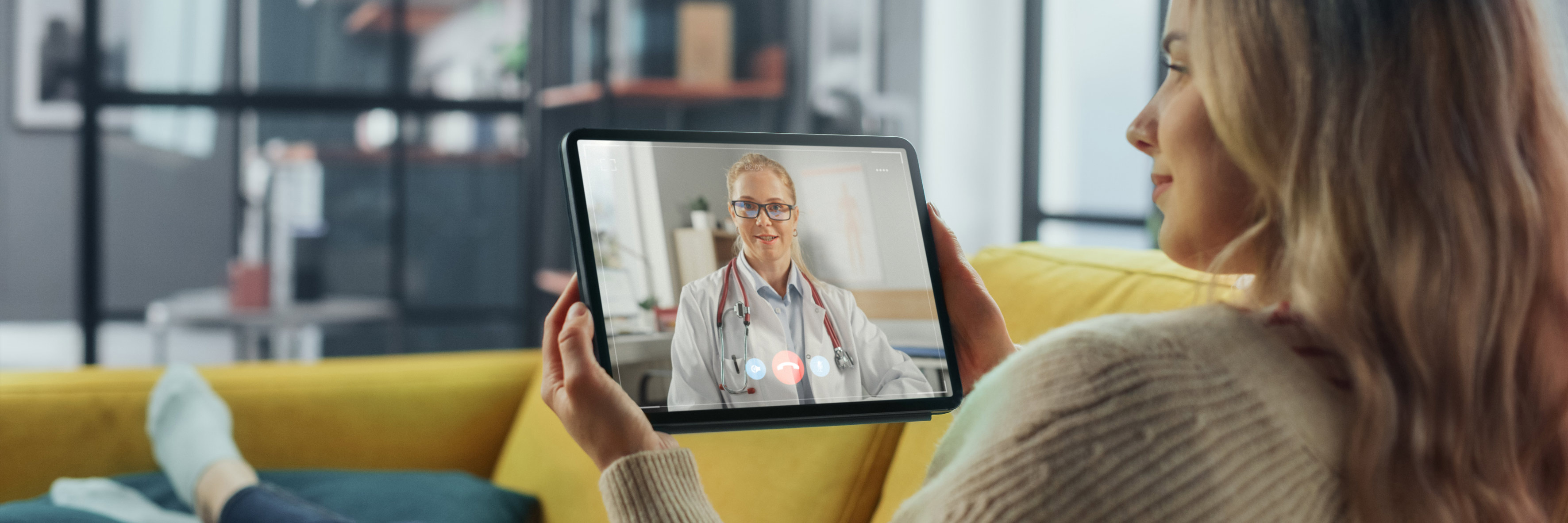 A woman video calling a doctor on a tablet