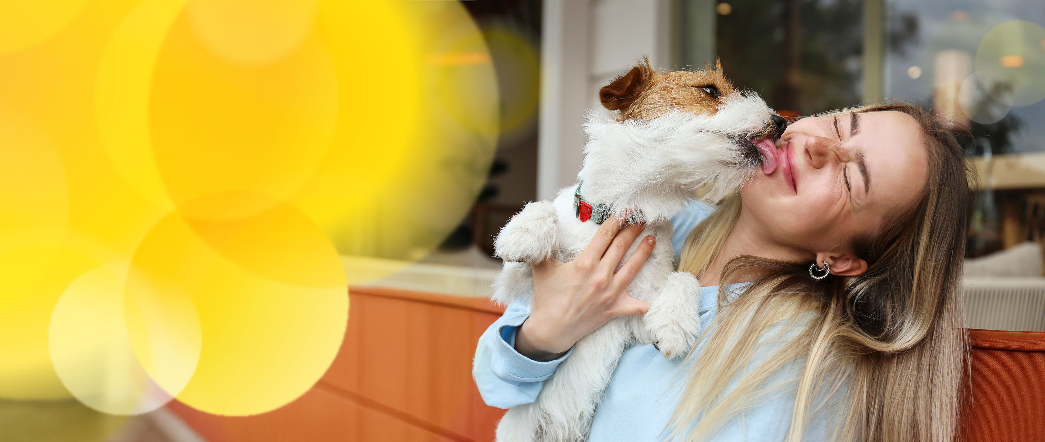 A happy woman holding her dog