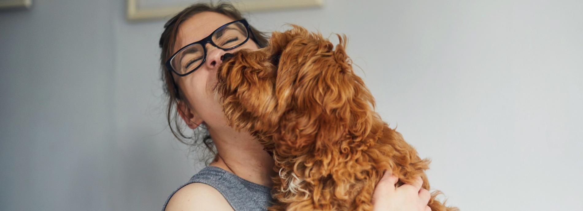 Woman hugging her cute dog