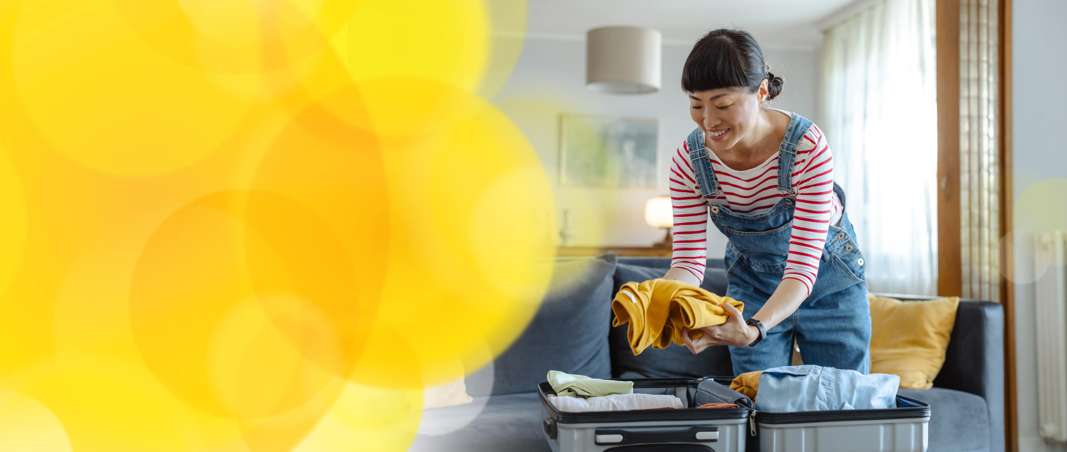 Smiling woman packing luggage