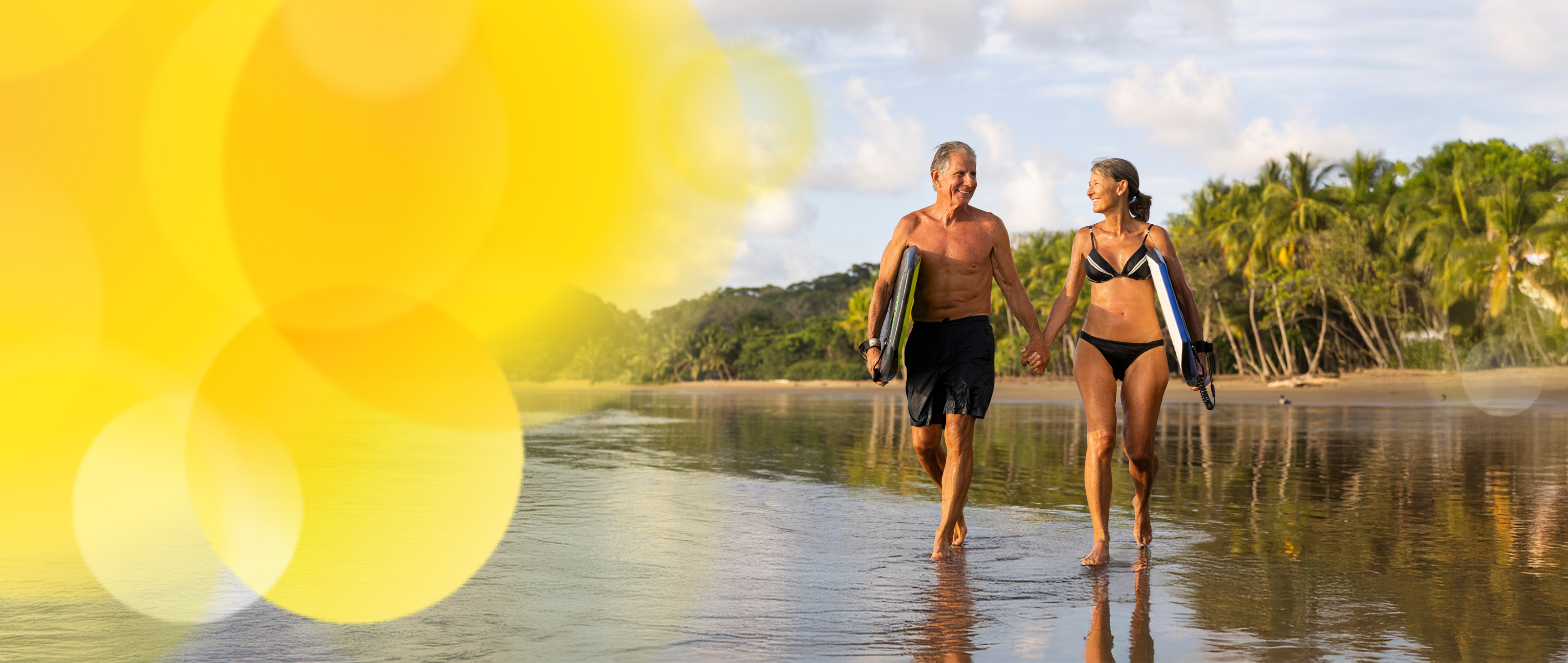 Couple smiling and walking along beach