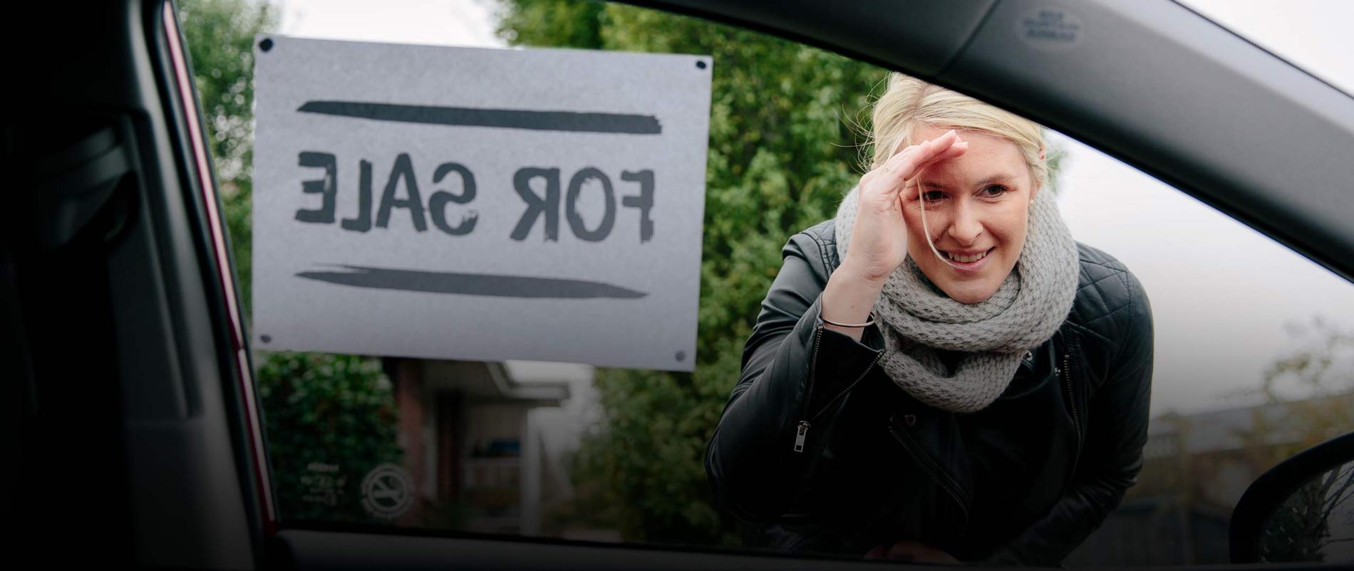 Woman looking inside the car window