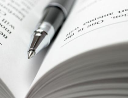 Close up of a pen sitting on an open book