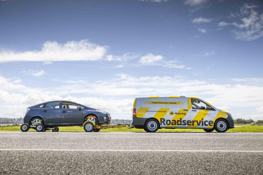AA Motoring Roadservice vehicle towing a broken down car