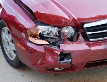 Close up photo of a red car's headlights