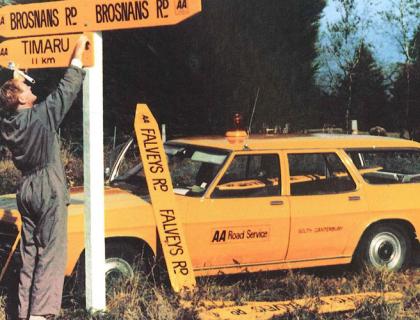 AA road service employee putting up road signage