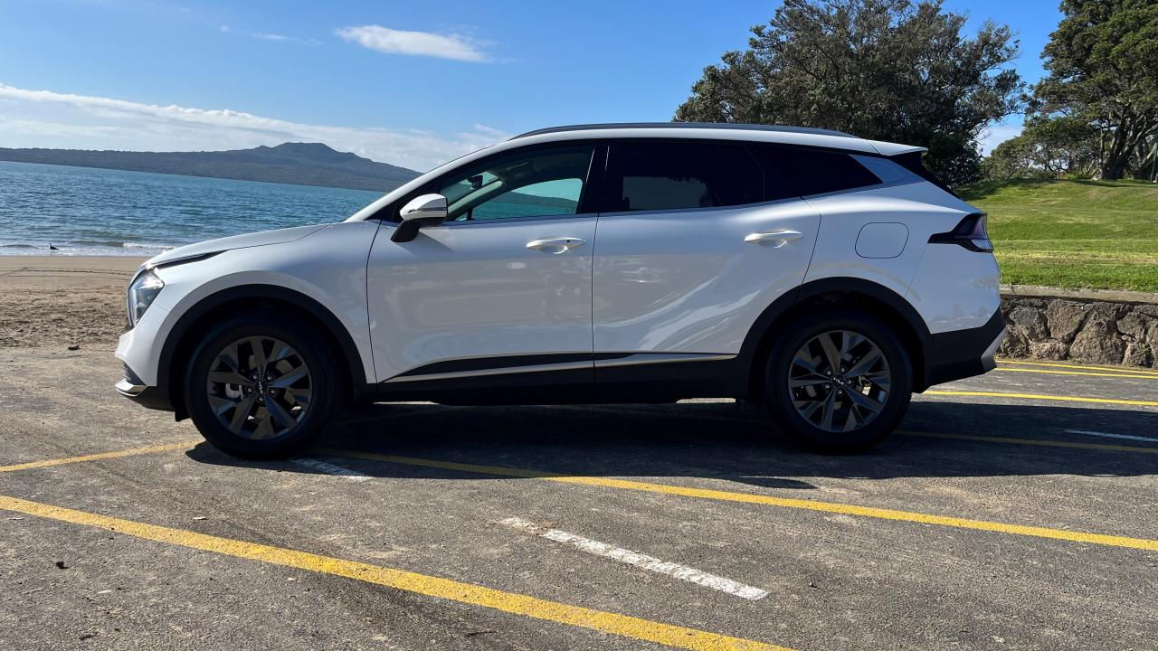 2024 Kia Sportage Hybrid Earth parked on the beach side