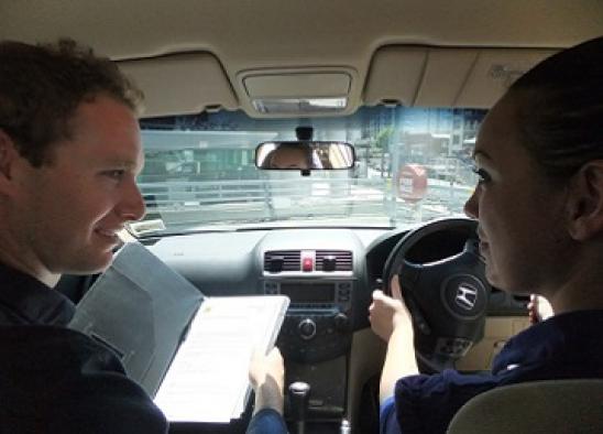 Driving instructor sitting next to the examinee