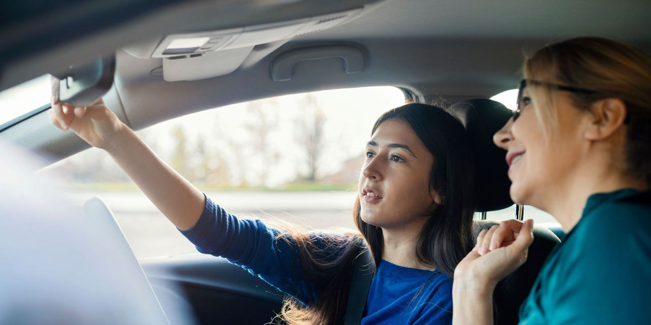 A woman driving instructor with a woman student driver 