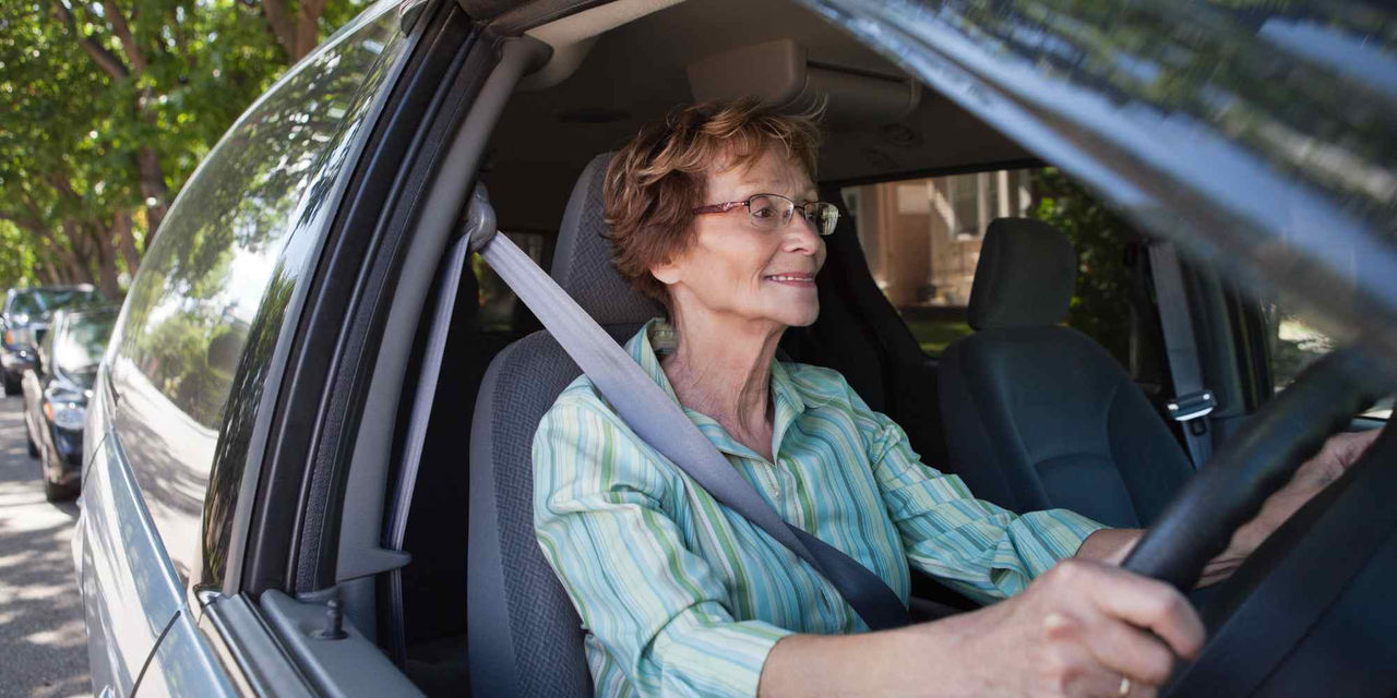 Elderly woman driving car