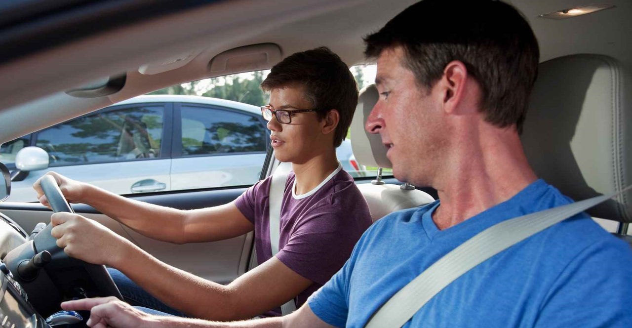 Dad teaching son to drive