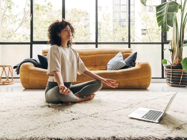 A woman doing yoga at her apartment