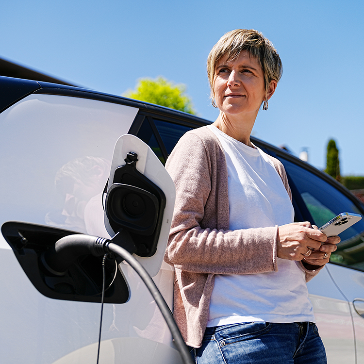 An EV owner waits for her car to charge.