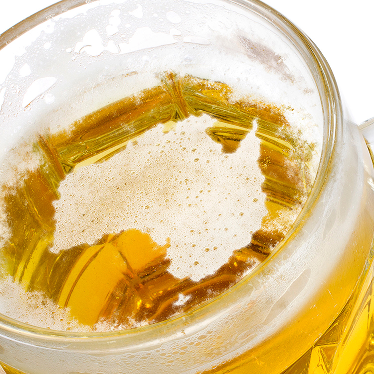 A beer glass with the foam in the shape of Australia's geographic borders