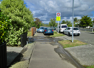 Photo of two cars parked illegally on the footpath